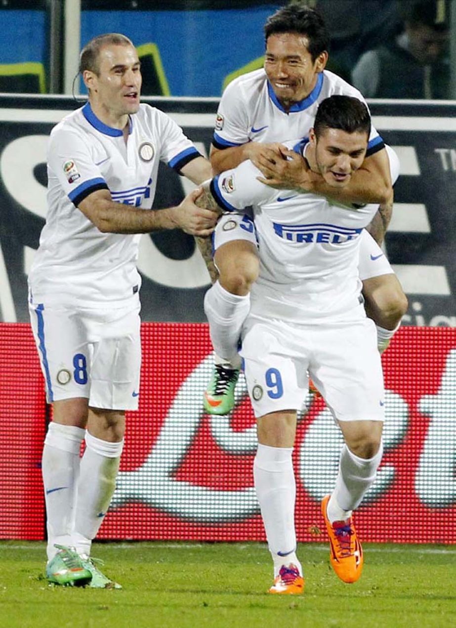 Inter Milan's Mauri Icardi (right) celebrates with teammates Rodrigo Palacio (left) and Yuto Nagatomo, on his back, after scoring during a Serie A soccer match between Fiorentina and Inter Milan at the Artemio Franchi stadium in Florence, Italy on Saturd