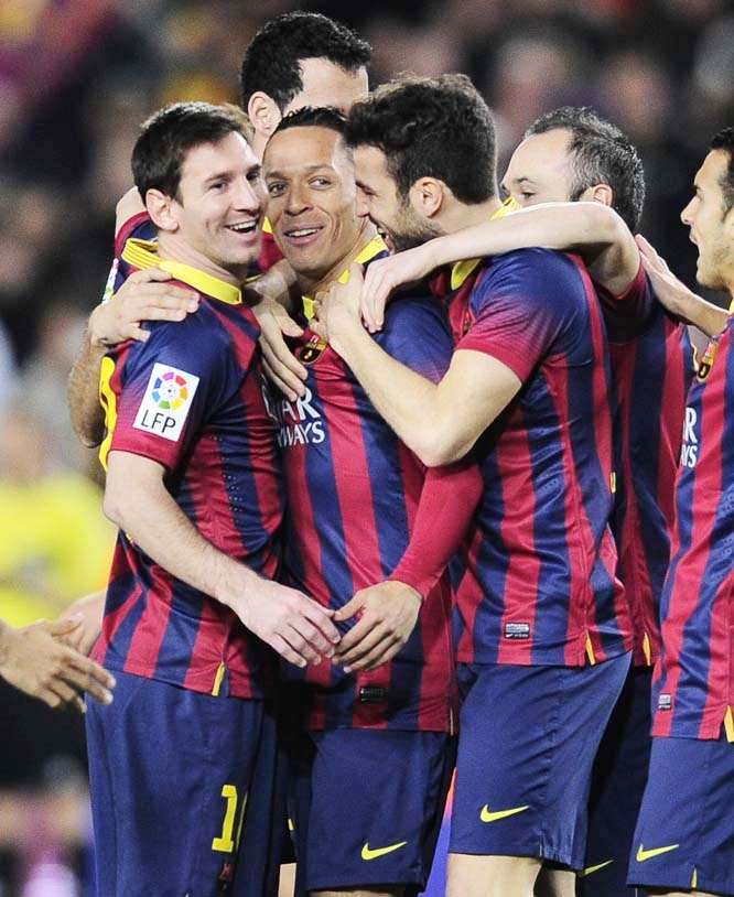 FC Barcelona's Adriano from Brazil (second left) reacts after scoring with his teammates Lionel Messi from Artentina (left) and Cesc Fabregas (third left) against Rayo Vallecano during a Spanish La Liga soccer match at the Camp Nou stadium in Barcelona,