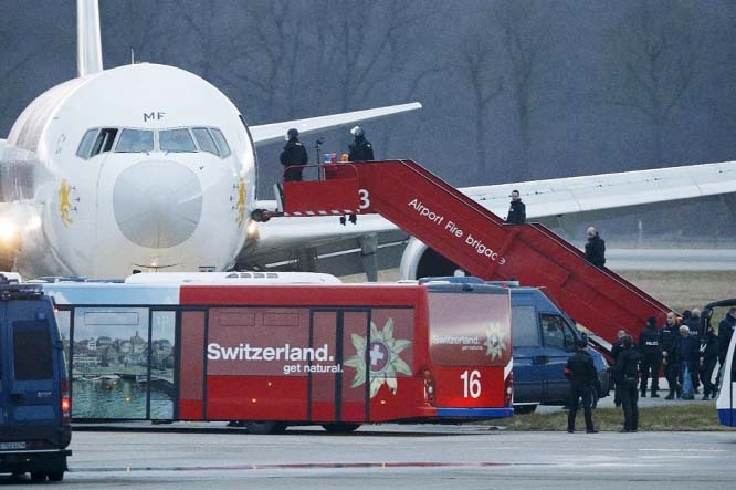 Police stand on the stairs after passengers were evacuated from a hijacked Ethiopian Airlines Plane on the airport in Geneva, Switzerland on Monday.