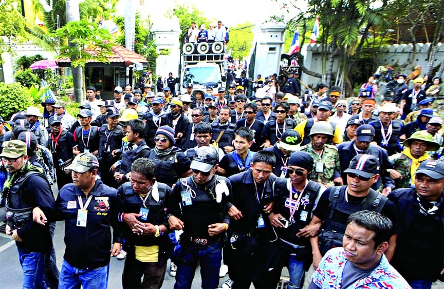 Anti-government protesters march into shut down the education ministry located near the prime minister's office of government house during a rally in Bangkok, Thailand on Monday.