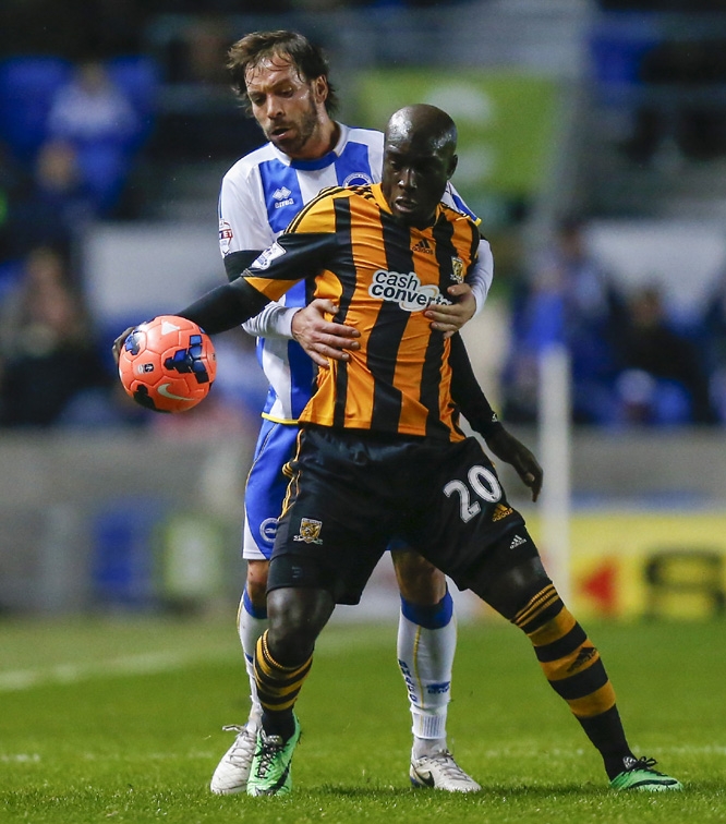 Hull City's Yannick Sagbo (front) in action against Brighton and Hove Albion's Inigo Calderon during the FA Cup fifth round soccer match at the AMEX Stadium, Brighton, England, Monday.
