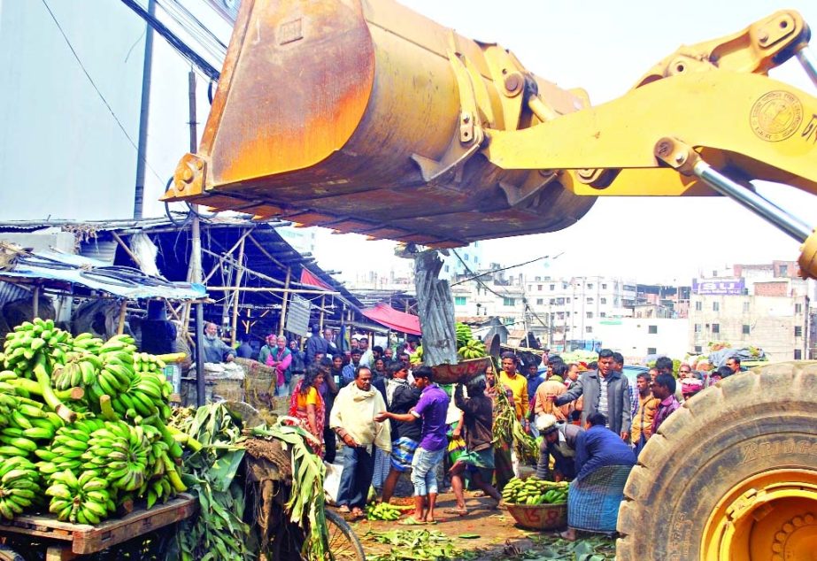 Illegal shops in city's Karwan Bazar being evicted by Dhaka South City Corporation team on Tuesday.