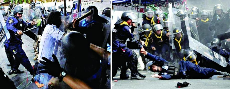 Riot police beat an anti-government protester during a clash in Bangkok (left). An injured Thai riot police officer is helped by his colleagues after a bomb attack on Tuesday.