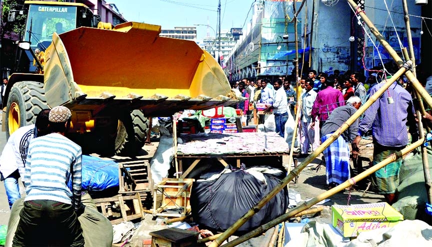 Illegal makeshift-shops around Bangabandhu National Stadium area in the city being evicted by the Dhaka South City Corporation team on Wednesday.