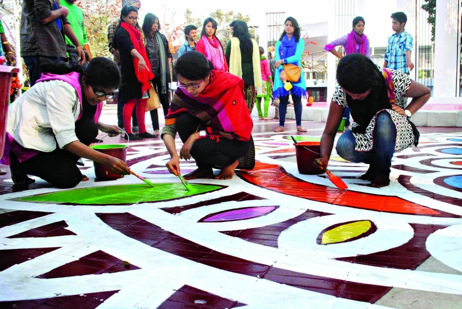 Students of the Institute of Fine Arts decorating areas in and around the Central Shahid Minar with alpana on Wednesday of Historic Ekushey February.