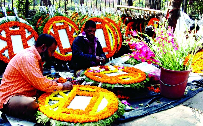 Flower traders busy in making bouquets and wreaths on Thursday near High Court area marking the Amar Ekushey today.