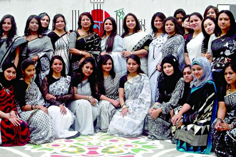 Teachers and students of the city's Master Mind School pose for photograph at the school premises on Friday after placing floral wreaths at the Shaheed Minar of the school marking International Mother Language Day.
