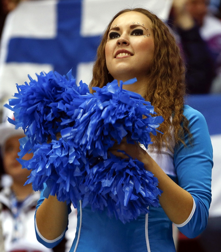 An Olympic cheerleader watches play between Finland and Sweden during the first period of a men's semifinal ice hockey game at the 2014 Winter Olympics in Sochi, Russia on Friday.