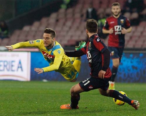 Napoli's Dries Mertens (left) and Genoa's Andrea Bertolacci vie for the ball during a Serie A soccer match between Napoli and Genoa at the San Paolo Stadium in Naples, Italy on Monday.