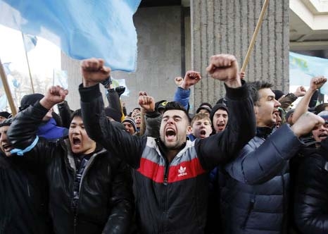 Crimean Tatars shout slogans during a protest in front of a local government building in Simferopol, Crimea, Ukraine on Wednesday.