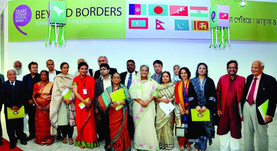 Prime Minister Sheikh Hasina along with poets and litterateurs of SAARC countries poses for photograph at the inauguration of SAARC Literary Festival-2014 in the auditorium of National Museum in the city on Thursday. BSS photo