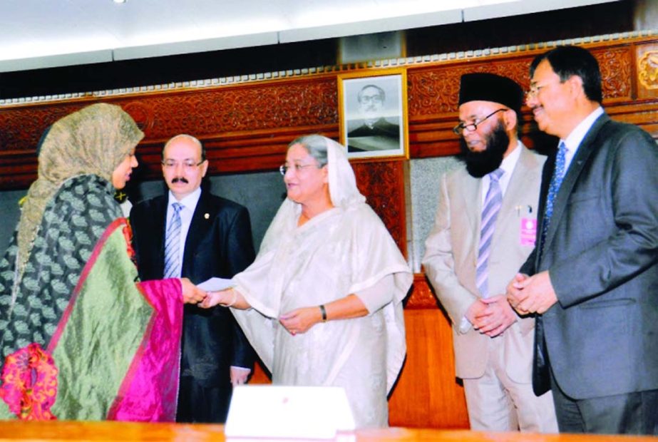 Prime Minister Sheikh Hasina handed over the sixth year's cheques of Tk 9.60 lakh to the families of two martyred Army officers killed in BDR carnage at Pilkhana as part of financial assistance by Prime Bank Limited at Prime Minister's Office recently.