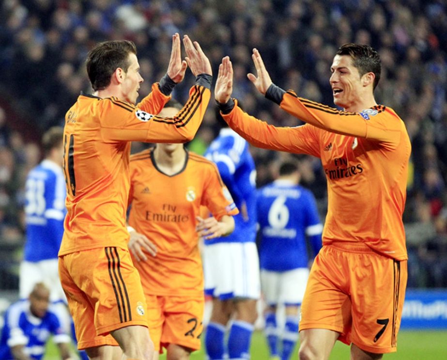 Real's Gareth Bale (left) celebrates his side's second goal with Real's Cristiano Ronaldo during the Champions League round of the last 16 first leg soccer match between Schalke 04 and Real Madrid in Gelsenkirchen, Germany on Wednesday.