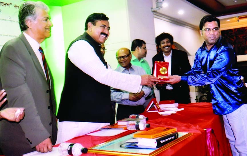 Shipping Minister Shajahan Khan giving International Mother Language citation to Rejaul Haque Bhuiyan for his contribution in social services at a hotel in the city recently.