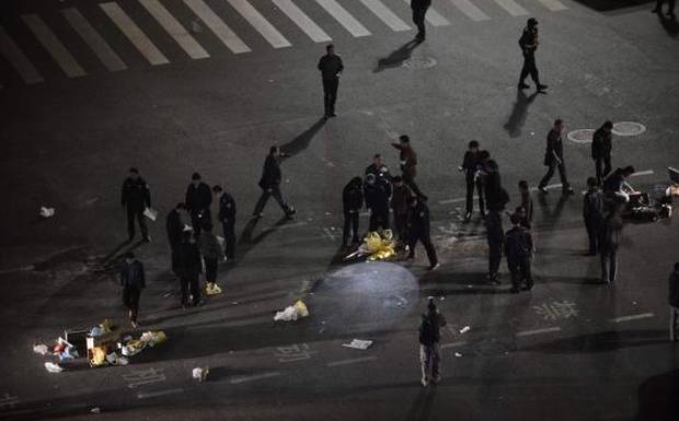 Police investigate after a group of armed men attacked people at Kunming railway station