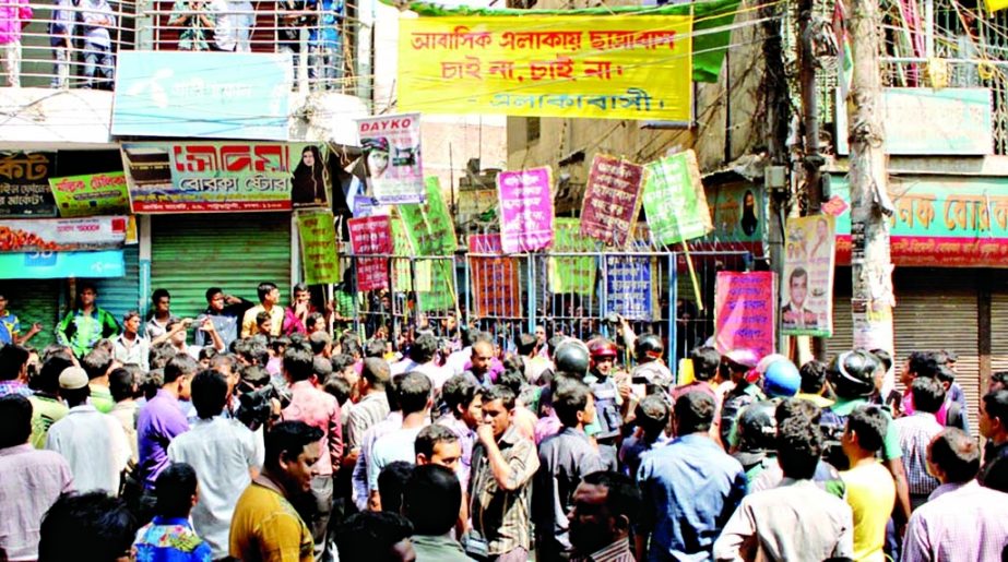 Locals and traders agitating in city's Patuatuli area on Sunday opposing setting up of any student dormitories in residential and market sites.