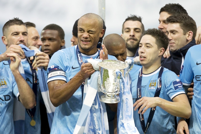 Manchester City players including captain Vincent Kompany (center left) celebrate after their 3-1 win against Sunderland in the League Cup final at Wembley Stadium, London, England on Sunday.