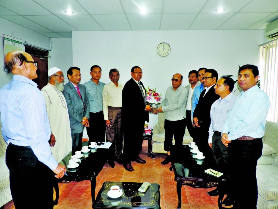 President of Bangladesh Indenting Agents' Association (BIAA) KMH Shahidul Haque presenting flower bouquet to Food Minister Advocate Md. Kamrul Islam MP at his office in the Bangladesh Secretariat on Tuesday. BIAA Directors Md. Sofiuddin Joarder, Md. Most