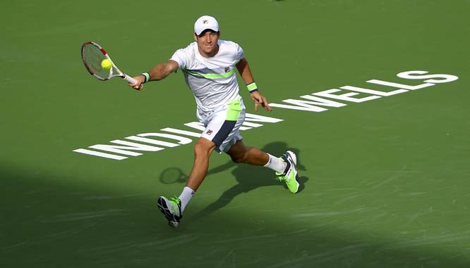 Dusan Lajovic of Serbia returns a shot to Thanasi Kokkinakis of Australia during a qualifying match at the BNP Paribas Open tennis tournament in Indian Wells, Calif on Tuesday.
