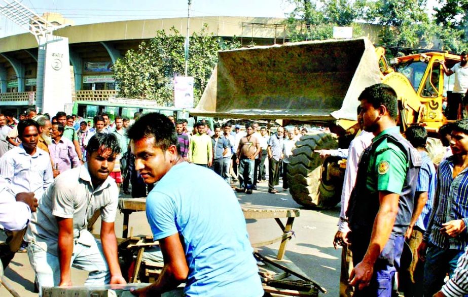 Dhaka City Corporation authority evicting illegal makeshift shops on footpaths ahead of T-20 World Cup Cricket. This photo was taken from city's Bangabandhu Avenue on Wednesday.