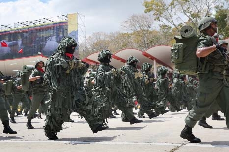 Venezuelan troops pass by during an official parade marking the first anniversary of Hugo Chavez's death in Caracas, Venezuela on Wednesday.