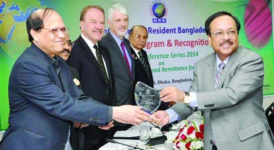 Managing Director and CEO of Prime Bank Limited Md Ehsan Khasru receives award from Governor of Bangladesh Bank Dr Atiur Rahman at a discussion meeting organized by Center for Non Resident Bangladeshis (NRB) titled "NRB Talent, Investment & Remittance fo