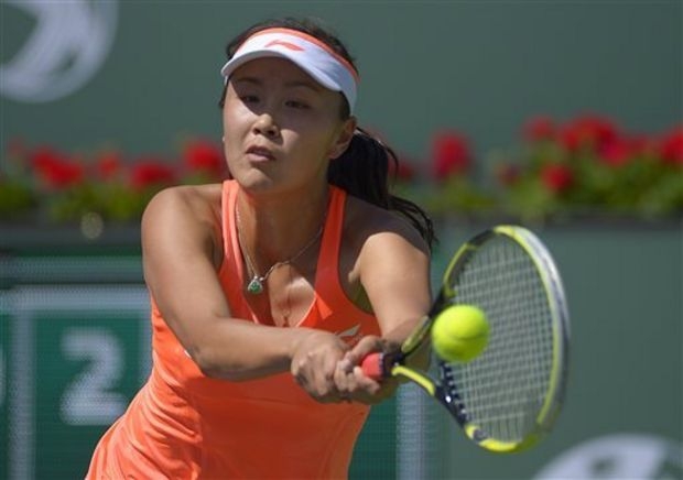Peng Shuai of China returns a shot against Vera Zvonareva of Russia during a first round match at the BNP Paribas Open tennis tournament in Indian Wells, Calif on Wednesday.