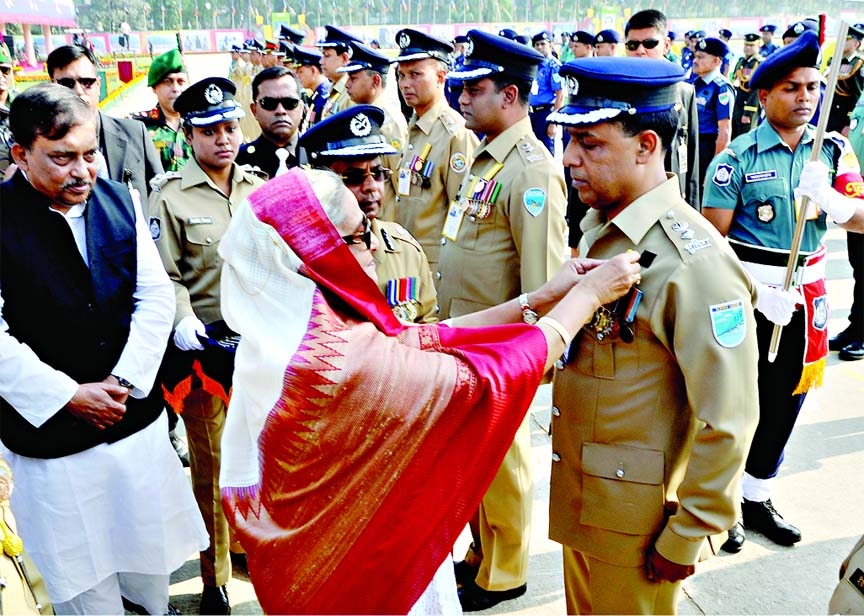 Prime Minister Sheikh Hasina adorns the BPM and PPM to 105 members of police forces for their outstanding contributions on the occasion of Police Week-â€™14 at Rajarbagh on Thursday.