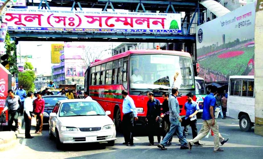 Pedestrians passing the busy road helter-skelter during rush hour taking life risk despite footover bridge over their heads. This photo was taken from Motijheel area on Friday.