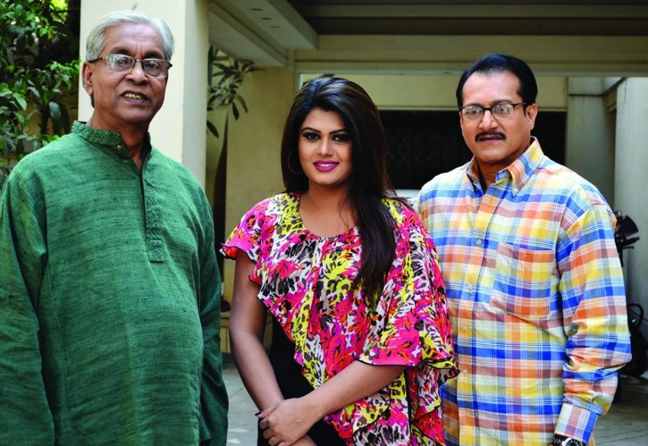 Noted filmmaker Chashi Nazrul Islam, heroine Moumita and film actor Subrata at a photo session in shooting spot of movie â€˜Matir Poriâ€™