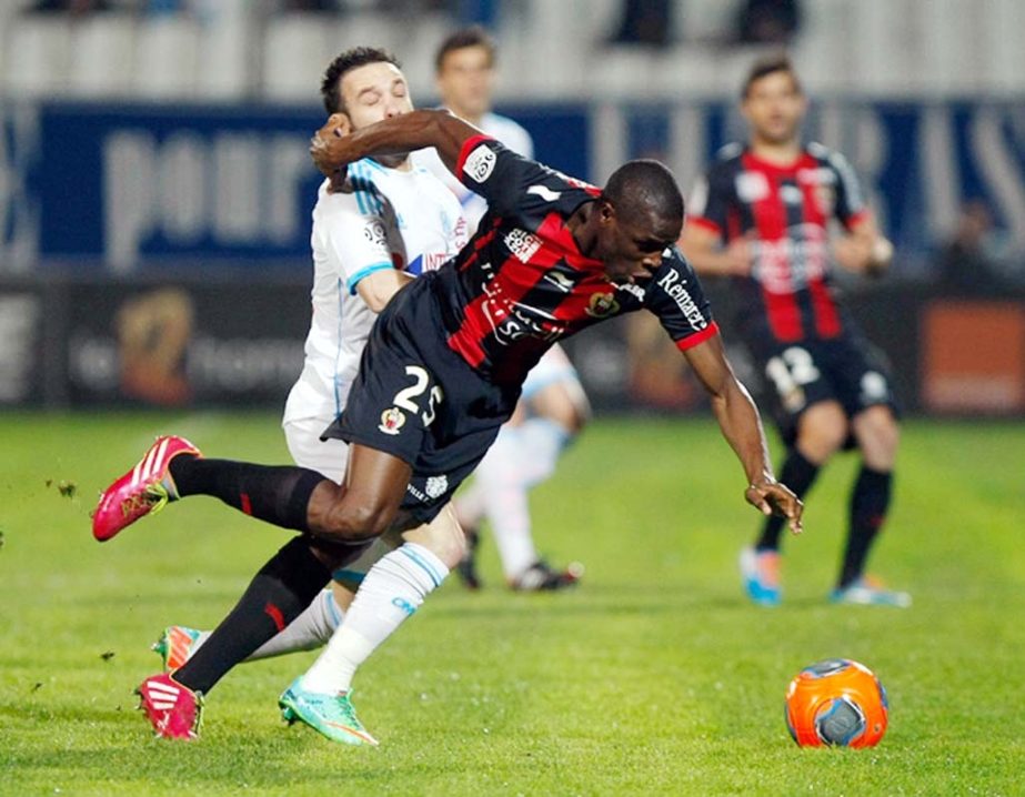 Nice's French defender Romain Genevois (right) challenges for the ball with Marseille's French midfielder Mathieu Valbuena, during their League One soccer match at the Velodrome Stadium in Marseille, southern France on Friday.