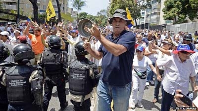 Police fired tear gas shells against protesters in parts of Caracas.