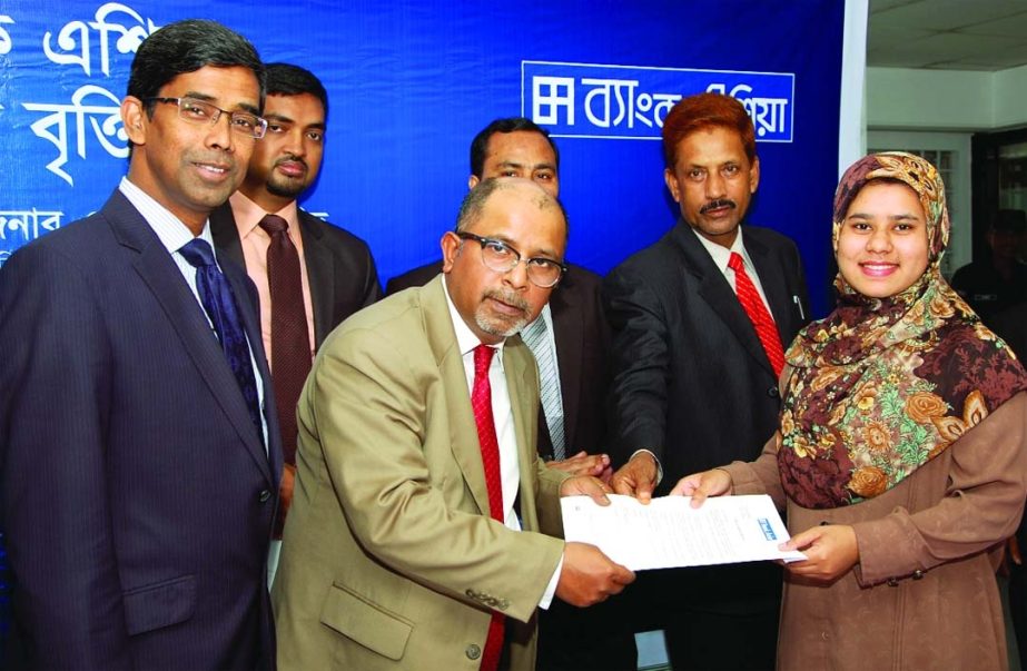 M Irfan Syed, Director of Bank Asia handing over scholarships to the insolvent meritorious 7 students of Tarail Upazila of Kishoreganj at the bank's Tarail branch premises on Saturday as part of its corporate social responsibility.