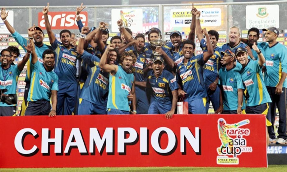 Sri Lankan cricketers and support staff celebrate with the trophy after winning the Asia Cup final match against Pakistan in Dhaka, Bangladesh on Saturday.