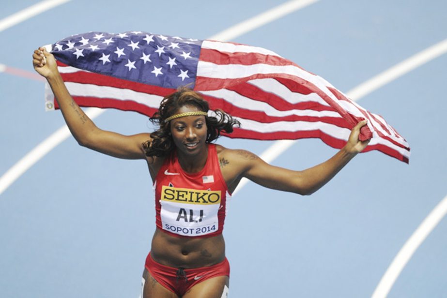 United States' Nia Ali celebrates with the US flag after winning gold in the women's 60m hurdles during the Athletics Indoor World Championships in Sopot, Poland on Saturday.