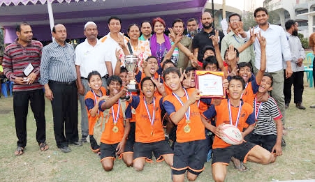 Rahmatullah Model High School, the champions of the Health First Mini Rugby Competition pose for a photo session at the Paltan Maidan on Sunday.