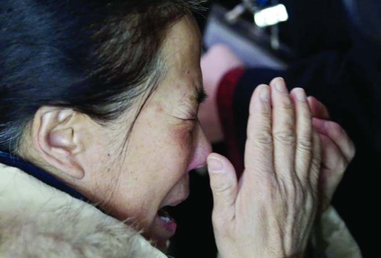 A woman crying for her missing relatives of KL Jet tragedy victims