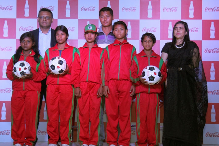 Some of the female footballers of the football school of Suehelama Mong, Country Manager of Coca-Cola Company Limited Debasish Deb, Deputy Chairperson of Women's Wing of Bangladesh Football Federation Mahfuza Akter Kiron and Suehelama Mong pose for camer