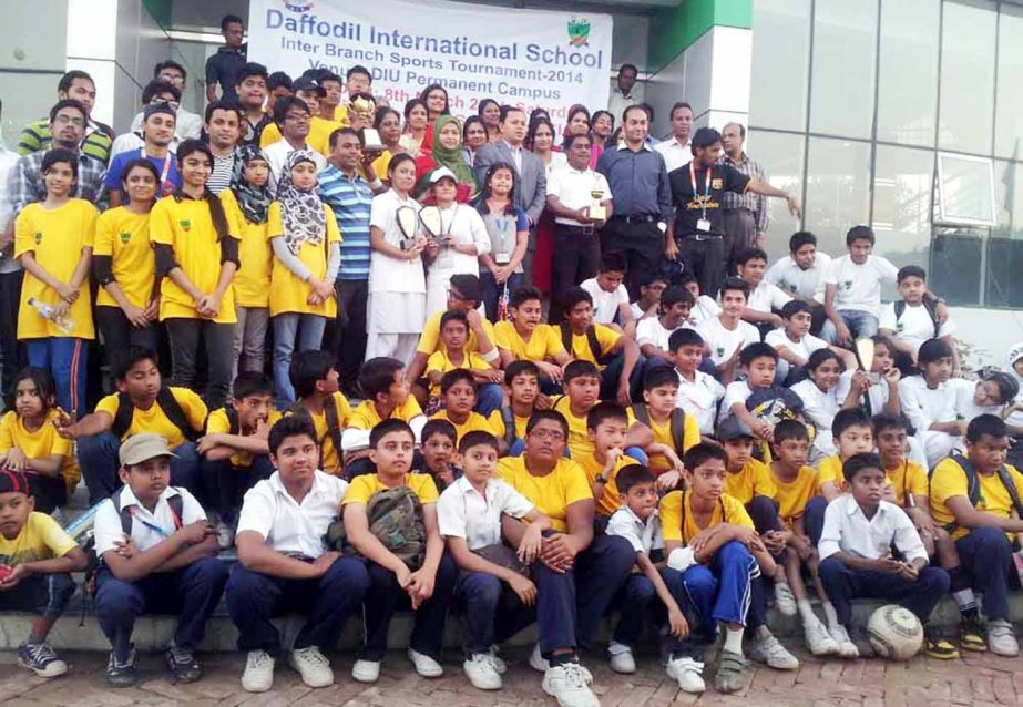 The participants of indoor and outdoor competitions of Daffodil International School (DIS) and the teachers of DIS pose for a photograph at the permanent campus of Daffodil International University in Ashulia recently. The two branches of DIS took part in
