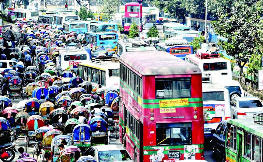 City witnessed massive gridlock as scores of rickshaws were plying through the busy road side by side with heavy vehicles near Jatiya Press Club on Monday.