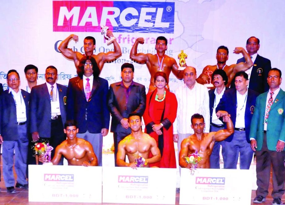 The winners of the Marcel Refrigerator Club Cup Open Bodybuilding Competition with the officials of Bangladesh Bodybuilding Federation and the guests pose for a photo session at the Auditorium of National Sports Council Tower on Tuesday.