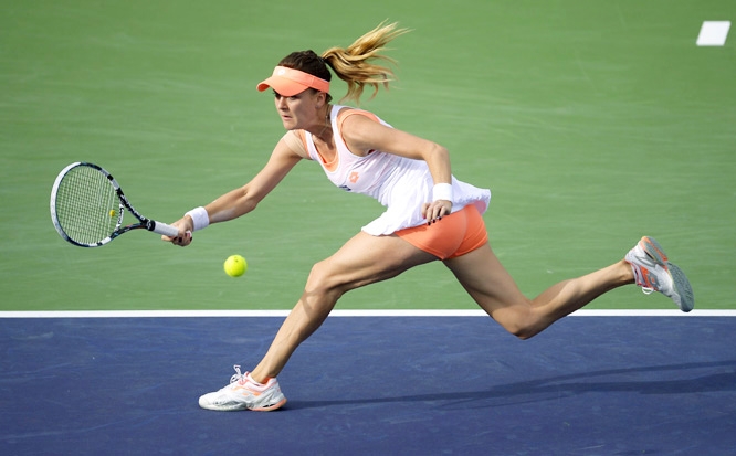 Agnieszka Radwanska of Poland reaches for a shot from Alize Cornet of France in their fourth round match at the BNP Paribas Open tennis tournament in Indian Wells, Calif on Tuesday.