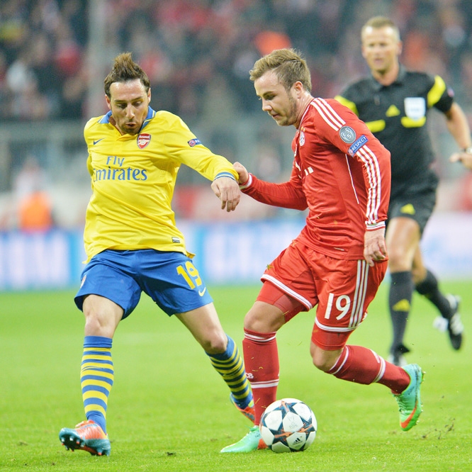 Bayern's Mario Goetze (right) and Arsenal's Santi Cazorla challenge for the ball during the Champions League round of the last 16 second leg soccer match between FC Bayern Munich and Arsenal FC in Munich, Germany on Tuesday.