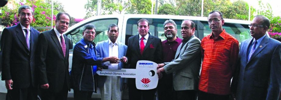 Former Chairman and Sponsor Shareholder of Dhaka Bank Limited ATM Hayatuzzaman Khan handing over key of a micro-bus to Secretary General of Bangladesh Olympic Association Syed Shahed Reza at the association premises on Wednesday. Dhaka Bank donated a micr