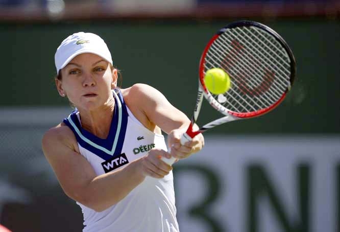 Simona Halep of Romania returns a shot against Casey Dellacqua of Australia during a quarterfinals match at the BNP Paribas Open tennis tournament in Indian Wells, Calif on Wednesday.