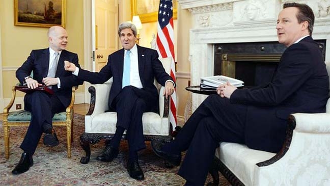 UK Prime Minister David Cameron, right and Foreign Secretary William Hague meet with US Secretary of State John Kerry in Downing Street, central London on Friday.