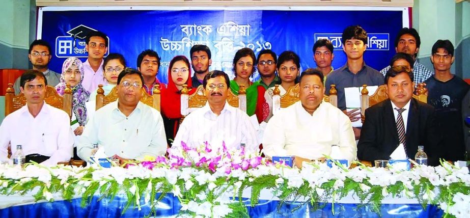 As part of corporate social responsibility, Md Mehmood Husain, President & Managing Director of Bank Asia poses with recipients of Bank Asia Higher Studies scholarship held at a local hotel at Lohagara in Chittagong recently.