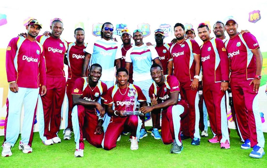The West Indies cricket team poses with the trophy after beating England 2-1, in the series of three T20 International cricket matches at the Kensington Oval in Bridgetown, Barbados on Thursday.