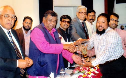 Social Welfare Minister Syed Mohsin Ali giving crest to Alhaj Salahuddin for his contribution in social services at a ceremony held recently at PID auditorium in the city.