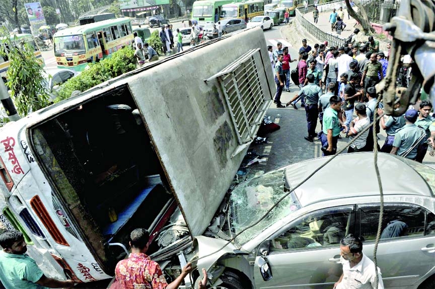 A speedy passenger bus turned turtle hitting a running private car near the Institution of Engineers' Bangladesh (IEB) in city on Friday.